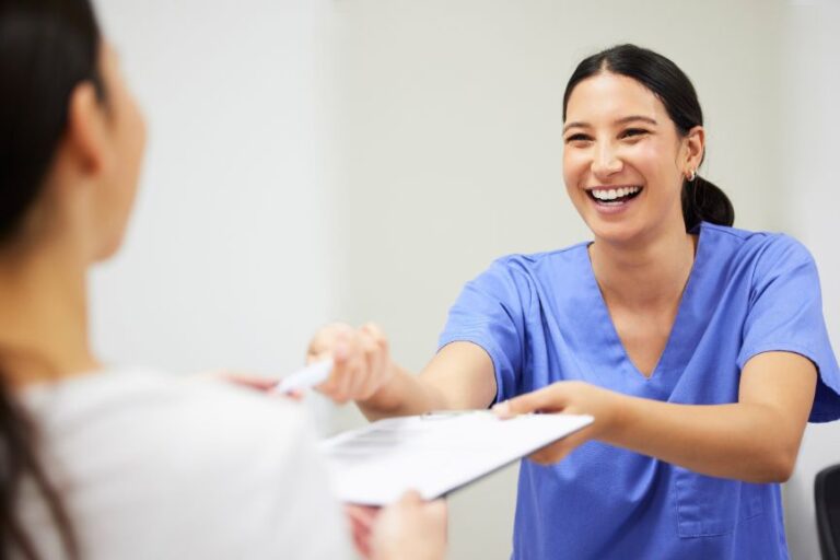 Dentist smiling while handling over the document