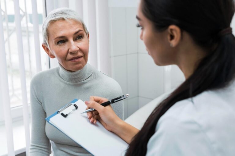 Doctor taking notes of Patient.