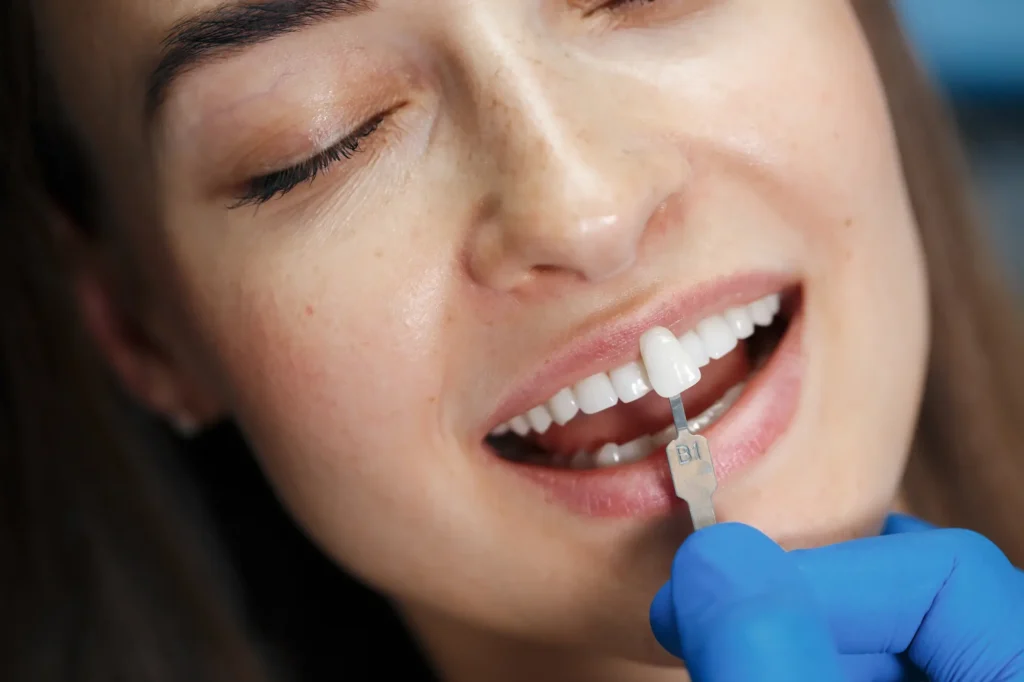 Close-up of a woman touching her cheek in discomfort from a toothache.